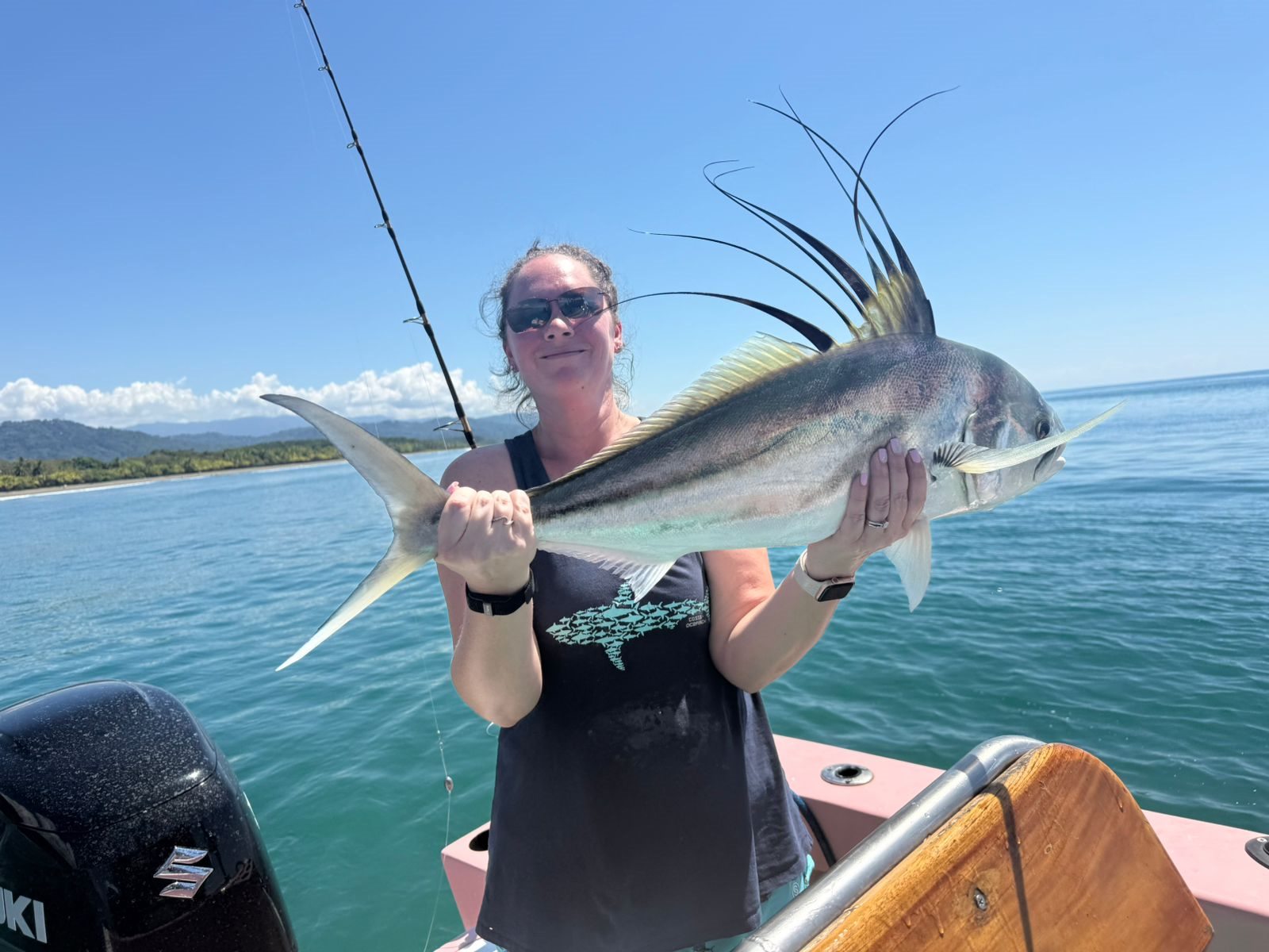 Woman smiling while holding a roosterfish