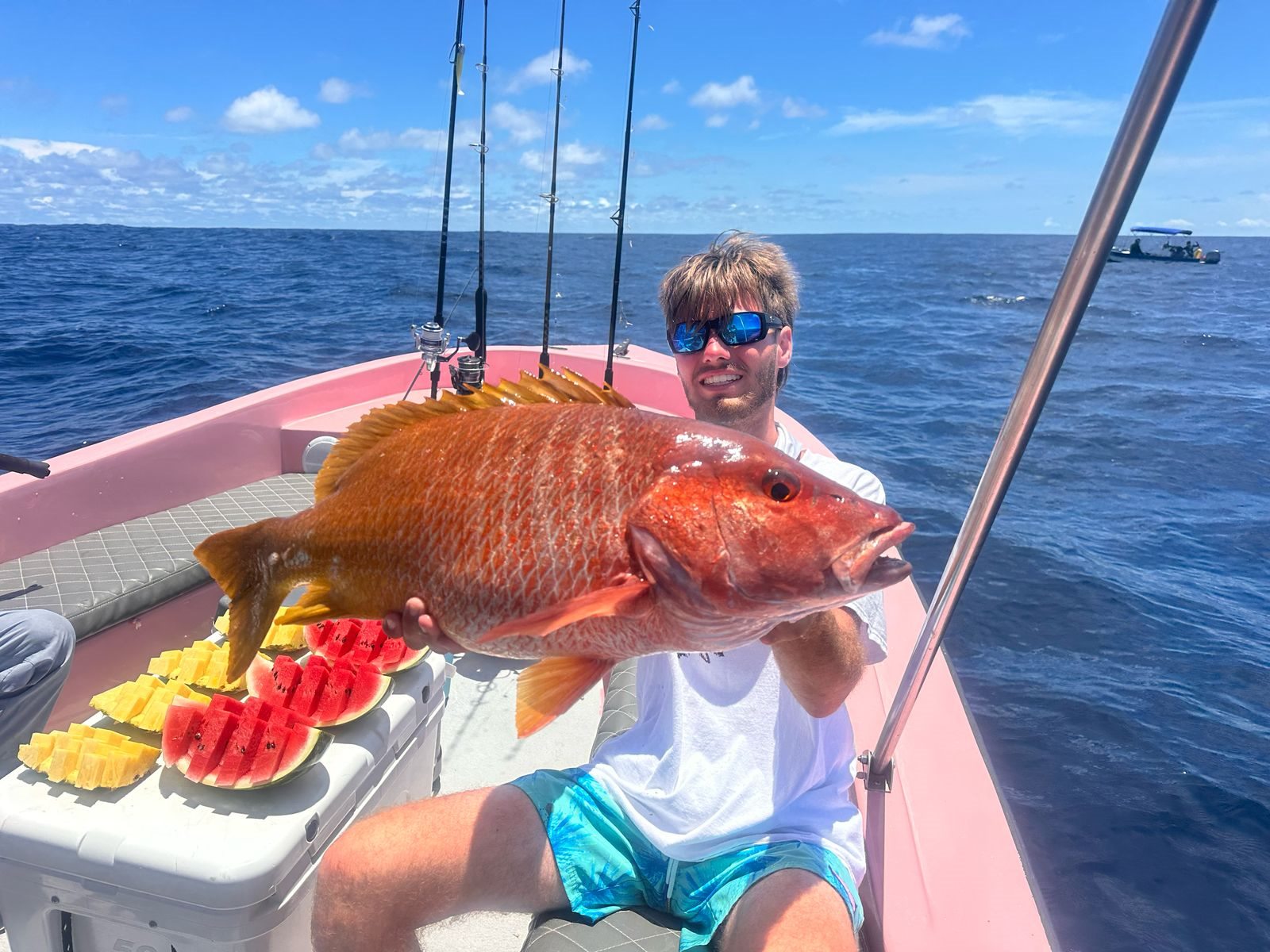 Adult angler holding a broad red snapper aboard Zapata Fishing