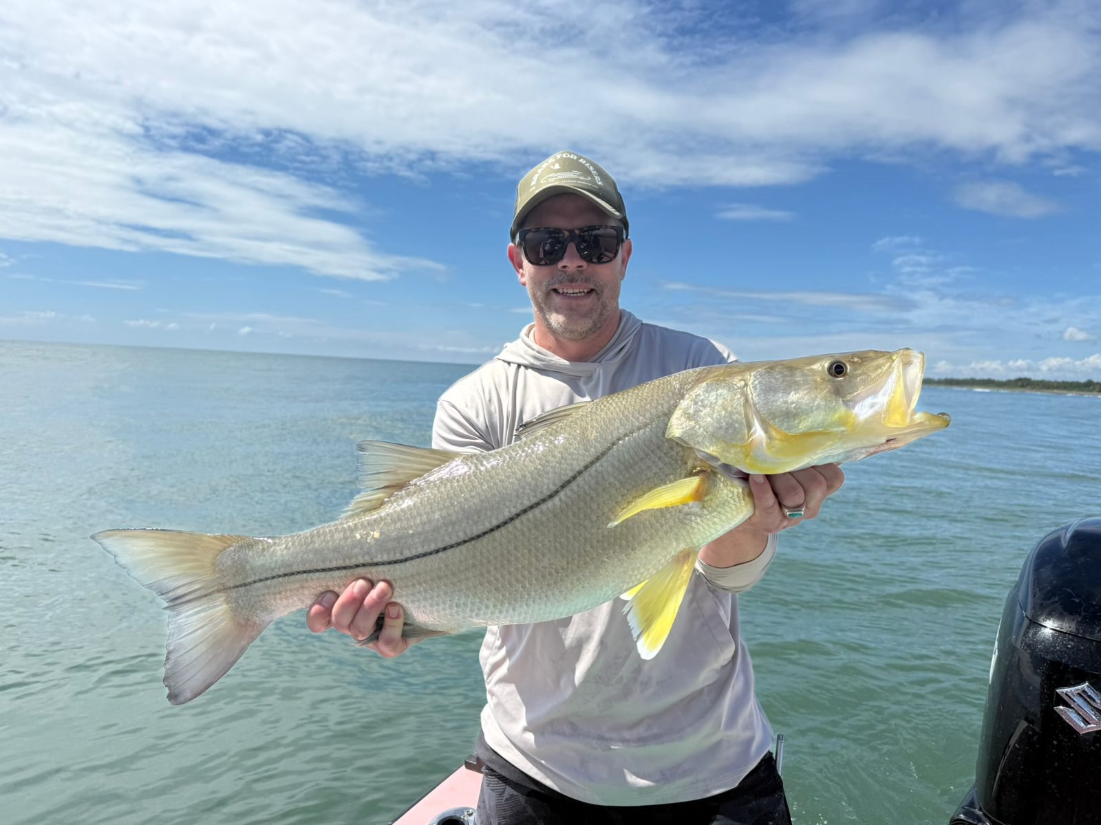 Angler holding an exceptionally large snook