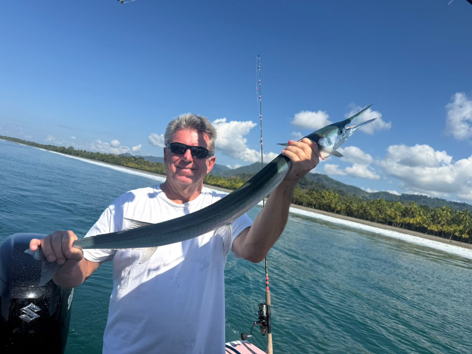 Adult angler smiling with a large silver Pacific fish