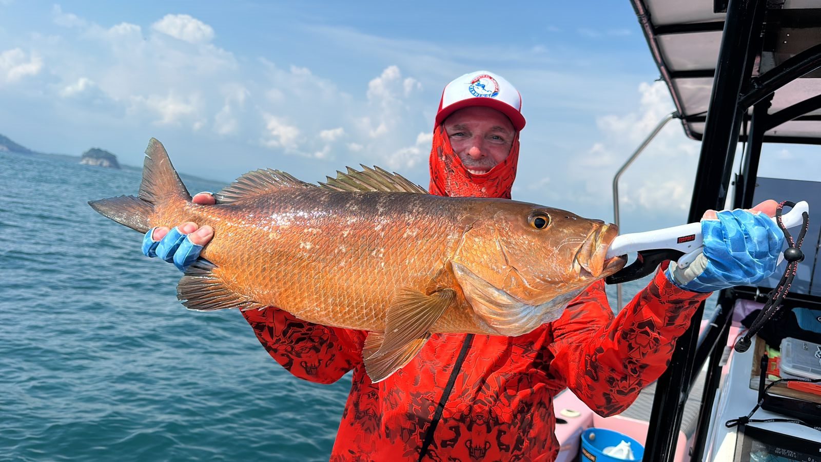 Angler holding a massive cubera snapper