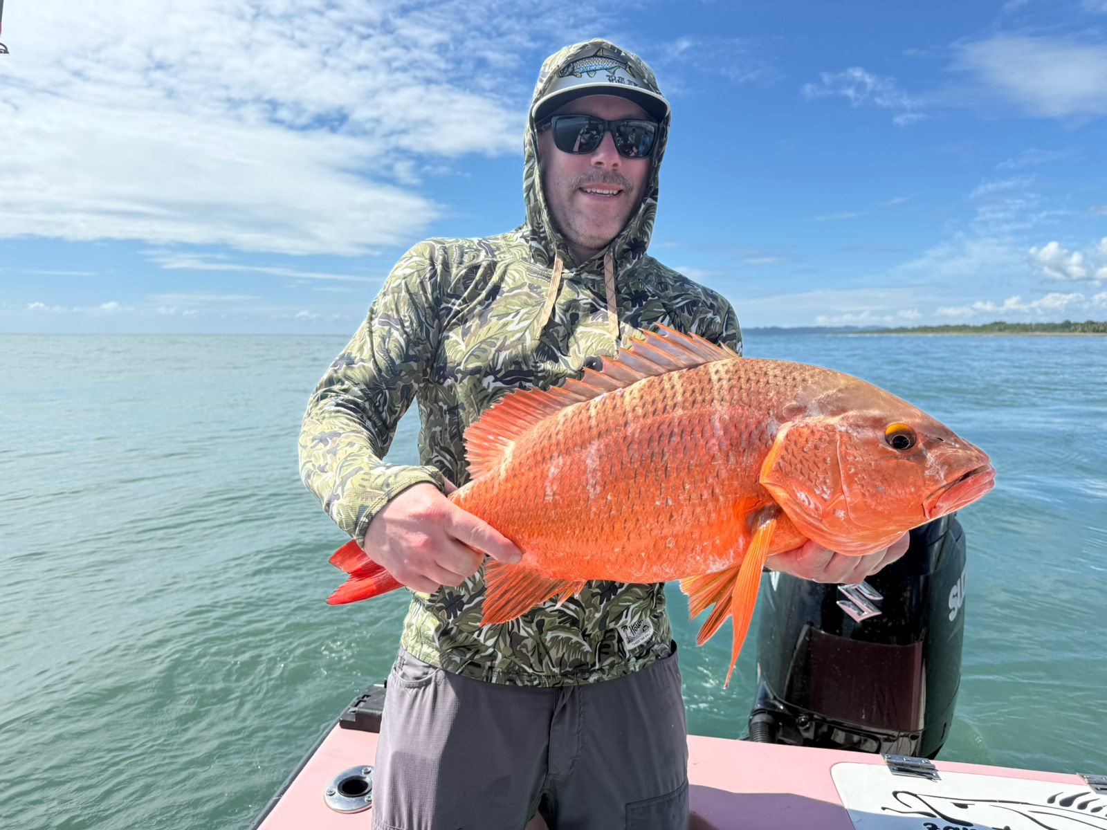 Adult angler holding a heavy red snapper