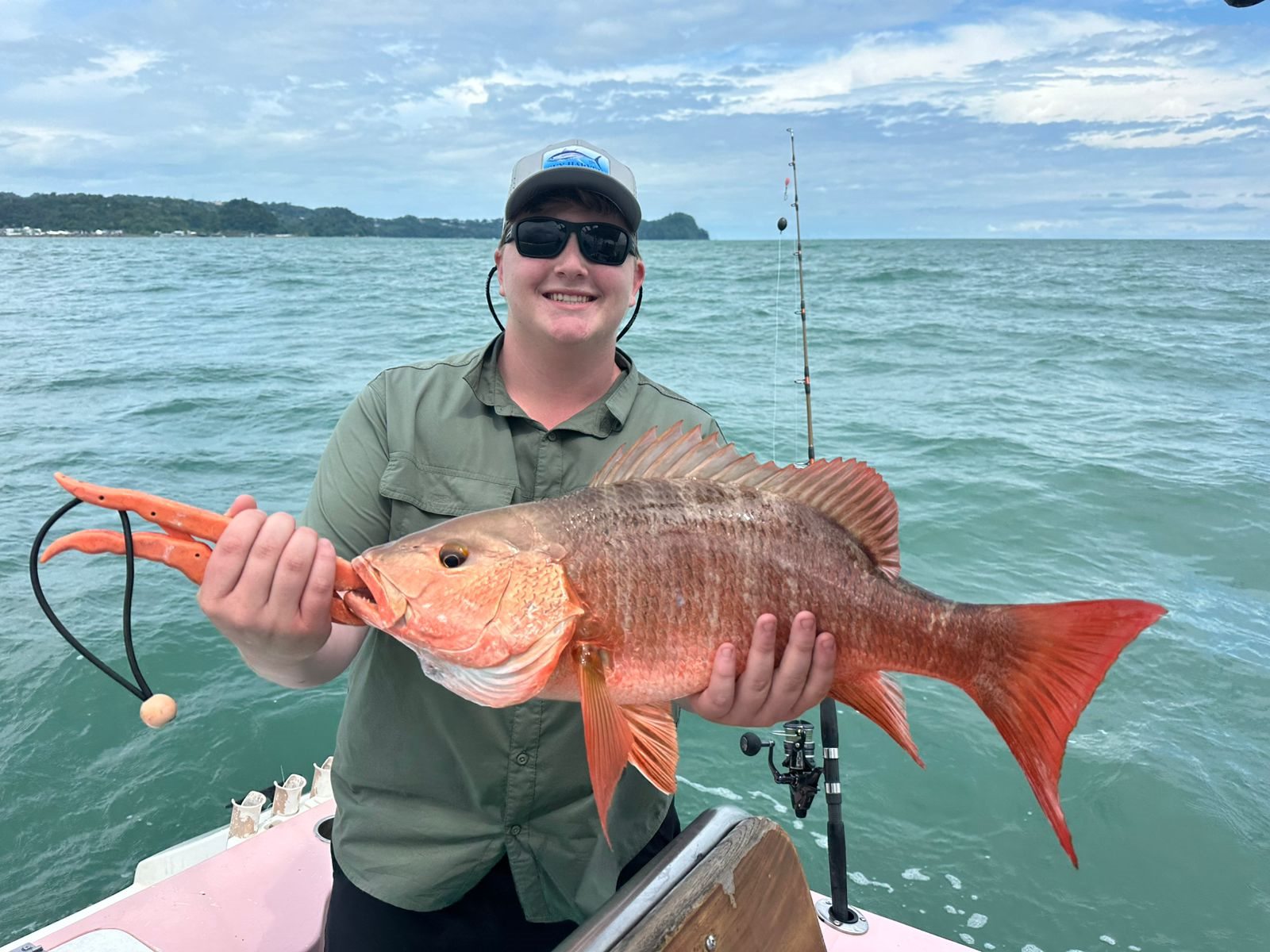 Happy angler holding a long red snapper
