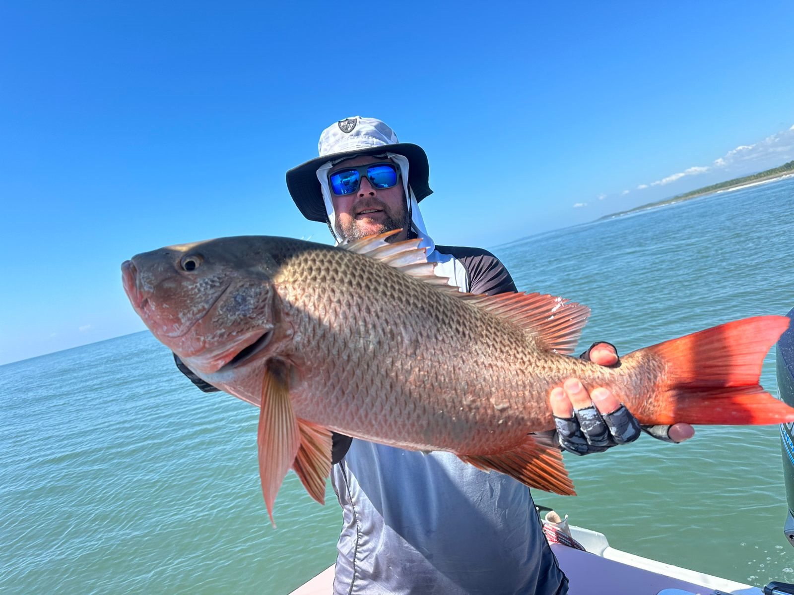 Angler holding a large silver snapper
