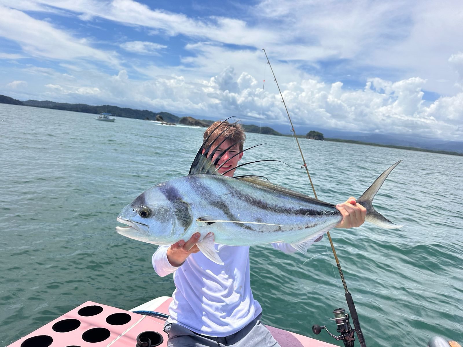Adult angler holding a roosterfish
