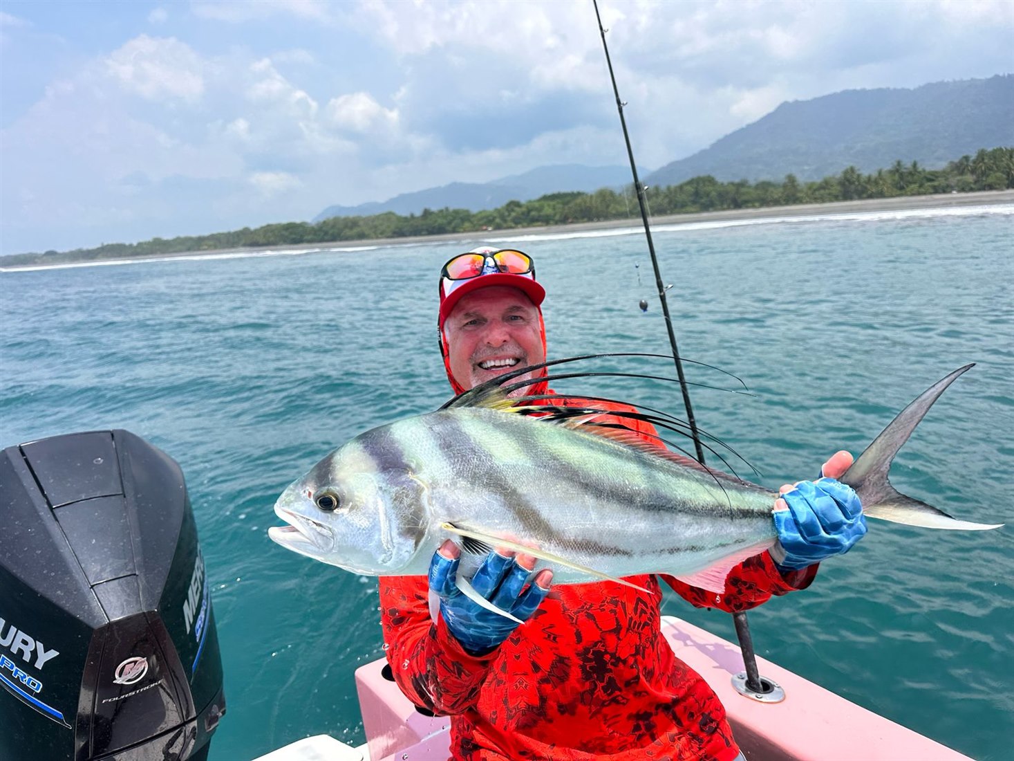 Happy angler holding a roosterfish near Quepos
